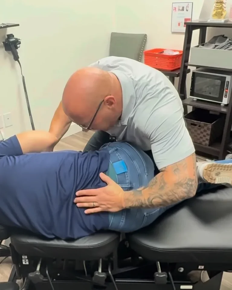 Dr. Tim Ballitch performing a side-lying low back chiropractic adjustment at Muscle Chiropractic in Glendale